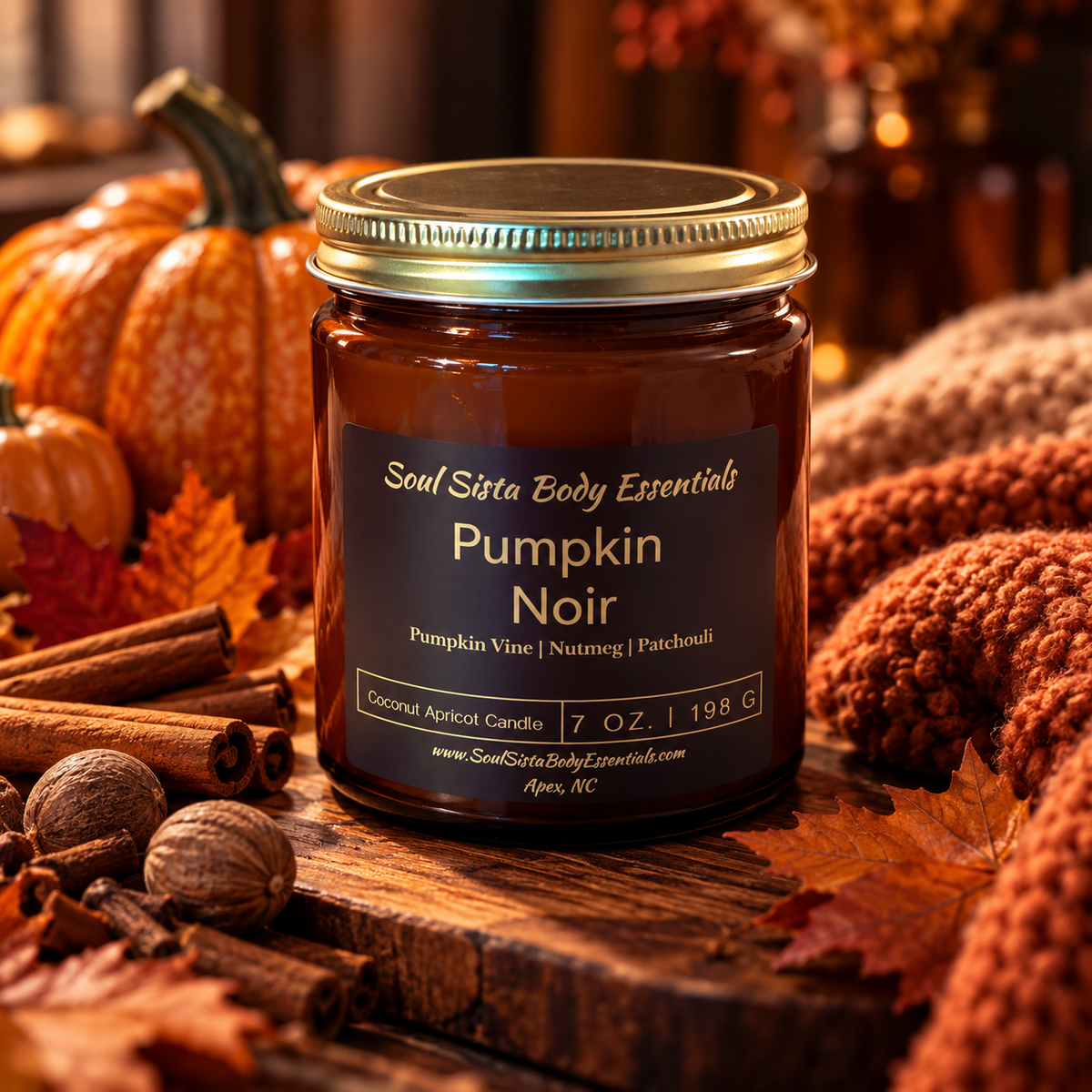 A Soul Sista Body Essentials candle in a glass jar with a lit wick, creating a warm, calming glow.